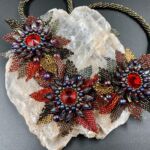 Beaded necklace with 3 colorful flowers by artist Jacqueline Aguilar