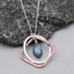 Necklace pendant with interlocking shapes and stone by artist Amy Muermann