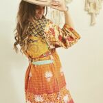 Woman with hat and orange patterned dress
