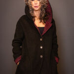 Woman wearing a black and red hooded jacket by artist Jane Miller