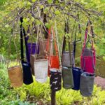 Colorful bags hanging on a tree by artist Leslie Krause
