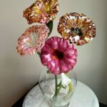 Colorful glass flowers in clear vase by Rachael Calderin