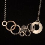 Necklace with interlocking circle pendants by artist Susanne Peltzman