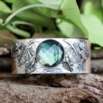 Ring band with green stone by artist Janet Reimund
