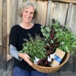 Paula Billig holding basket with fresh botanicals