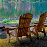 2 chairs in front of a lake photography by artist Debbie Warner